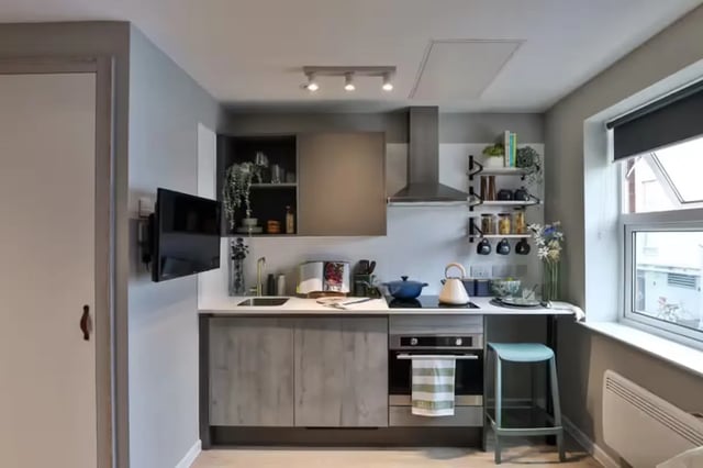 Modern grey kitchen with white counter and stool kitchen at Brook Studios in Birmingham Student Accommodation