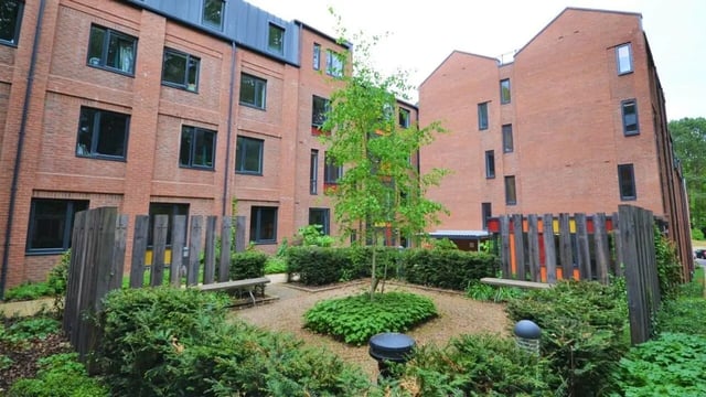 Brick buildings with outdoor seating area exterior at The Village at The Viaduct in Durham Student Accommodation