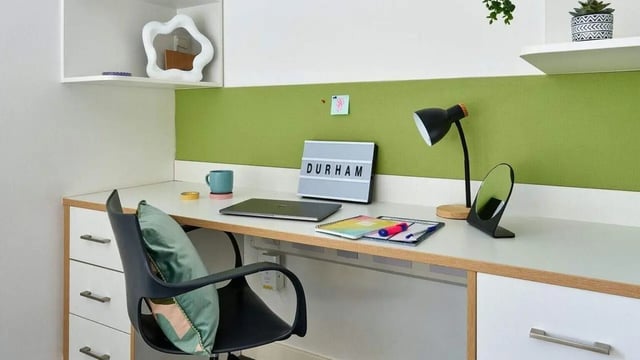 Desk chair laptop light mug light box notebook study area at The Village at The Viaduct in Durham Student Accommodation