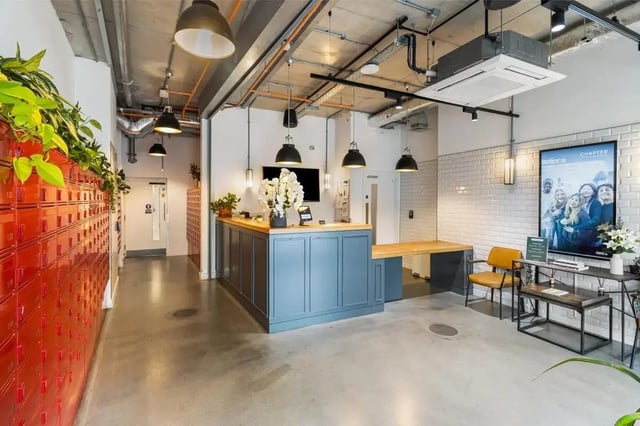 Reception desk with lockers and seating area at Chapter Highbury II in London Student Accommodation