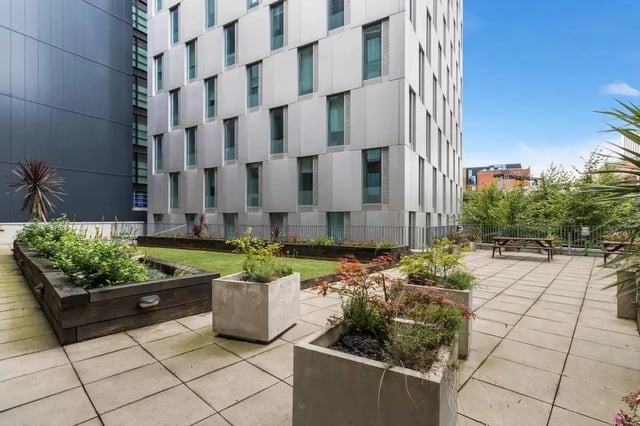 Courtyard with plants picnic tables and building exterior exterior at Chapter South Bank in London Student Accommodation