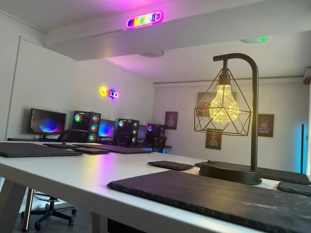 Computers monitors neon lights table study area at College Court in Stoke-On-Trent Student Accommodation