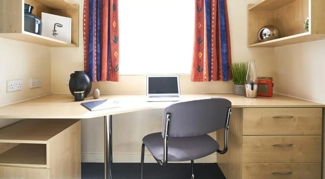 Laptop, chair, drawers, shelves, study area at College Court in Stoke-On-Trent Student Accommodation