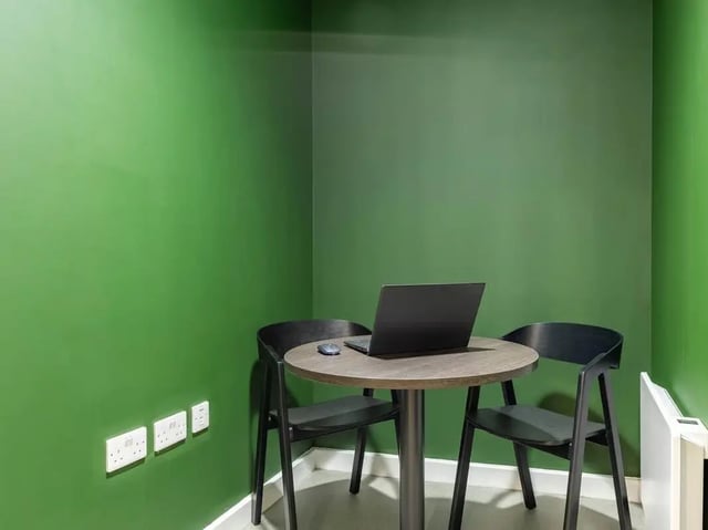 Table with laptop and chairs study area at Straits Aire in Leeds Student Accommodation