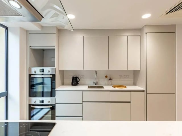White cabinets double ovens kettle sink modern kitchen at Straits Aire in Leeds Student Accommodation
