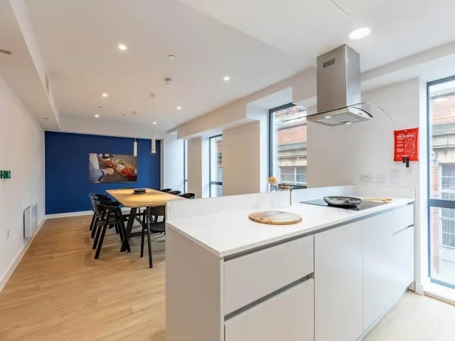 Modern kitchen with dining area and appliances kitchen at Straits Aire in Leeds Student Accommodation