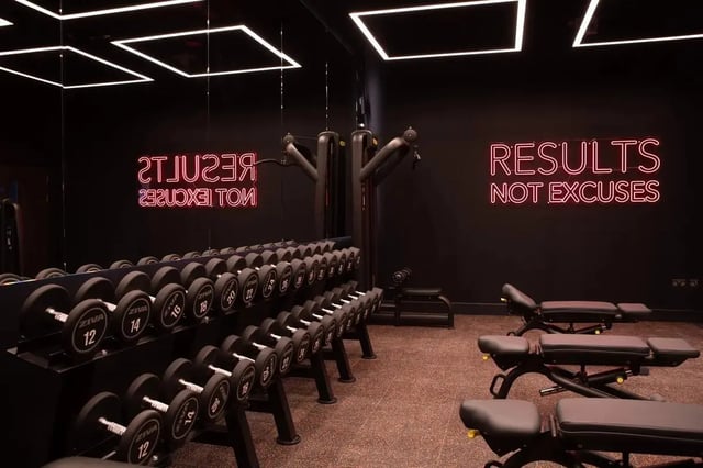 Dumbbells weight benches neon sign gym at Centre Court in Nottingham Student Accommodation
