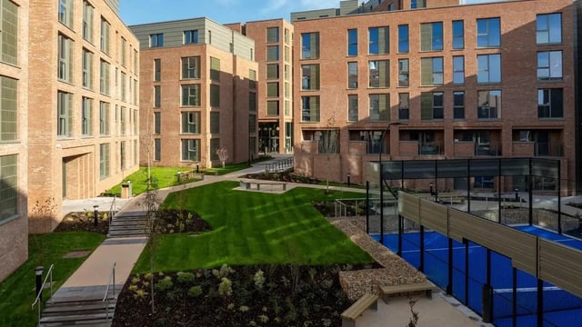 Brick buildings courtyard with green lawn and court exterior at Centre Court in Nottingham Student Accommodation
