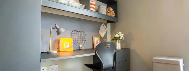 Desk with lamp chair and storage study area at Element Manchester in Manchester Student Accommodation