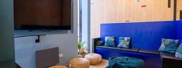 Blue bench with leaf pillows and beanbags lounge area at Element Manchester in Manchester Student Accommodation