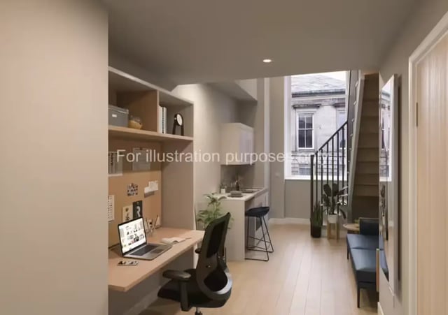 Desk chair laptop shelves kitchen stairs seating area living room at Glasgow Citi View in Glasgow Student Accommodation