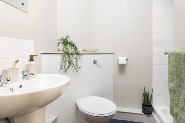 Sink toilet with plant and towel Bathroom at Archways in Sheffield Student Accommodation