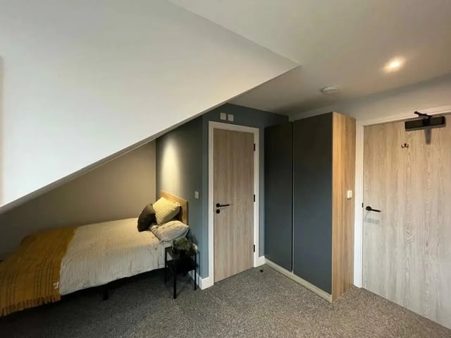 Bed wardrobe doors and bedside table bedroom at Commercial Point Nottingham in Nottingham Student Accommodation