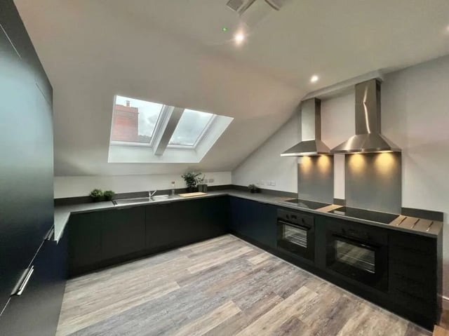 Modern dark kitchen with skylights and ovens kitchen at Commercial Point Nottingham in Nottingham Student Accommodation