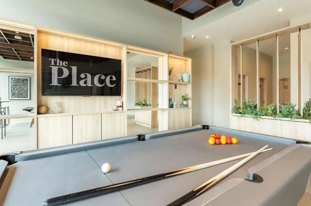 Pool table with balls cues and large screen living room at The Place in Nottingham Student Accommodation