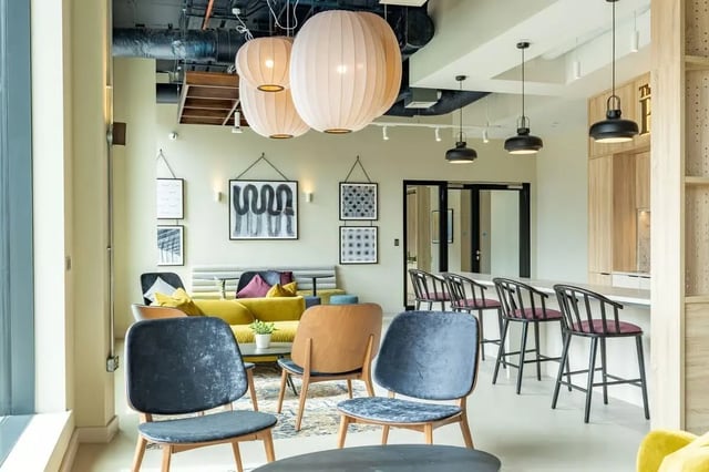 Chairs couch bar stools artwork kitchen living room at The Place in Nottingham Student Accommodation