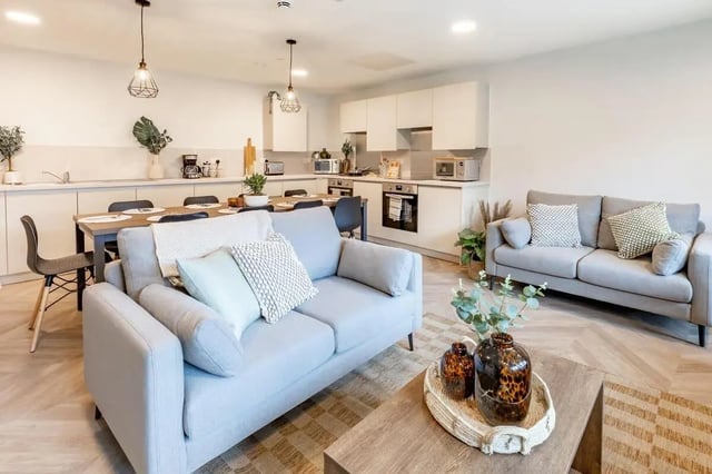 Light grey sofas dining table modern kitchen living room kitchen at The Place in Nottingham Student Accommodation