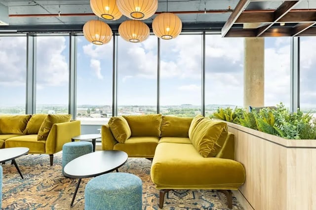 Yellow sectional sofa coffee tables and ottomans living room at The Place in Nottingham Student Accommodation