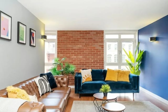 Two sofas brick wall plants artwork living room at Cornerhouse in Sheffield Student Accommodation