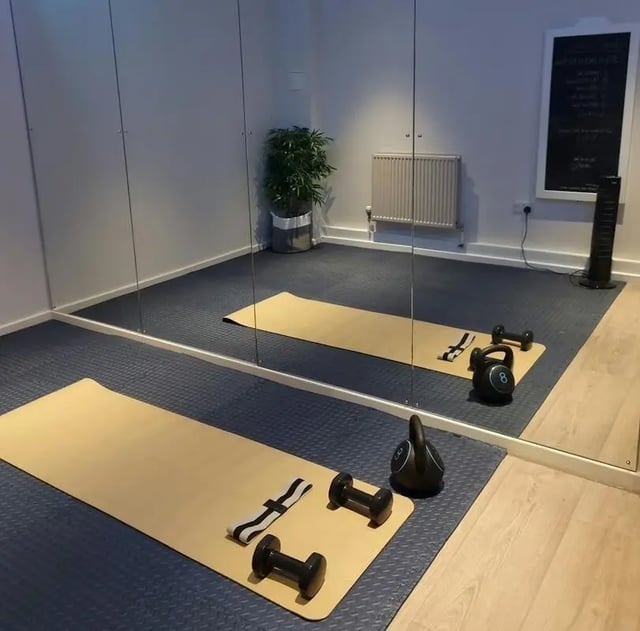 Yoga mats dumbbells kettlebell chalkboard gym area at Laycock Studios in Sheffield Student Accommodation