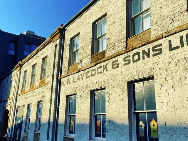 Brick building with windows and birdhouses exterior at Laycock Studios in Sheffield Student Accommodation
