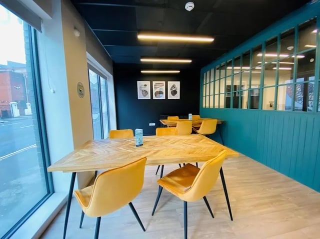 Wooden tables yellow chairs communal area at Laycock Studios in Sheffield Student Accommodation