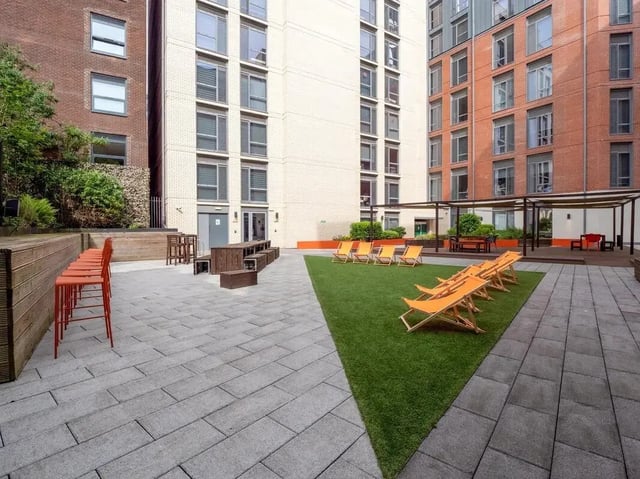 Orange chairs wooden benches outdoor seating exterior at Crown House in Sheffield Student Accommodation