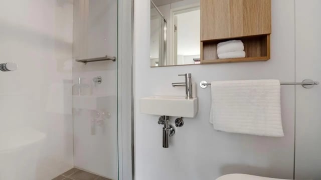 Sink mirror shower and towel Bathroom at UniLodge Auckland Central in Auckland Student Accommodation