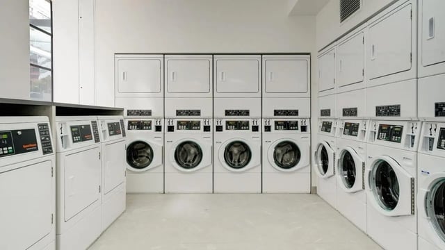 Washing machines and dryers stacked in rows Laundry room at UniLodge Auckland Central in Auckland Student Accommodation