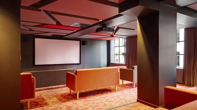 Projector screen couches and red floor movie room at UniLodge Auckland Central in Auckland Student Accommodation