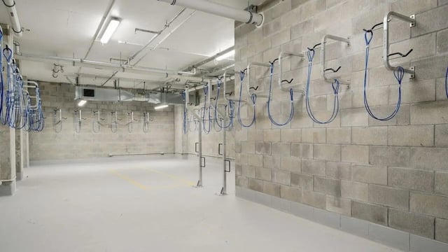 Wall mounted bike racks with blue straps storage area at UniLodge Auckland Central in Auckland Student Accommodation