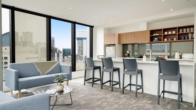 Sofa bar stools and kitchen counter Living room at UniLodge Auckland Central in Auckland Student Accommodation