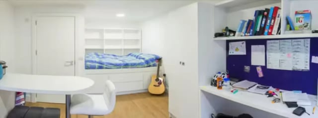 Bed guitar desk and books bedroom at The Colston in Bristol Student Accommodation