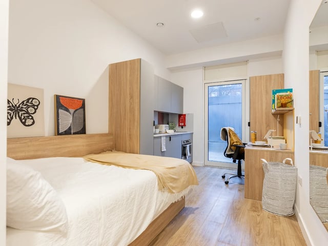 Bed desk kitchen and a chair study area at Beckton House in Nottingham Student Accommodation