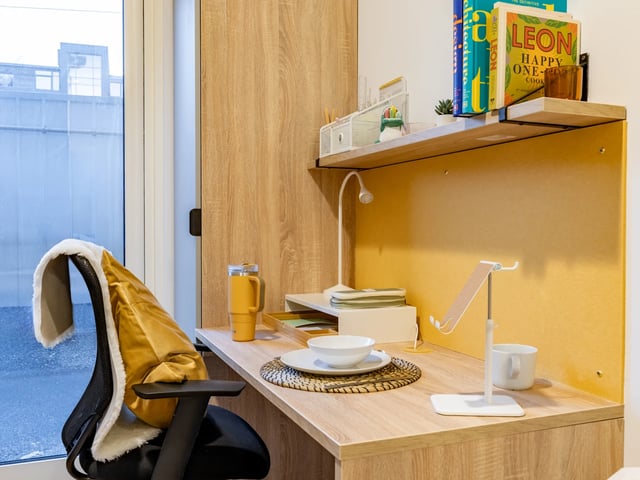 Desk with chair books mug and bowl study area at Beckton House in Nottingham Student Accommodation