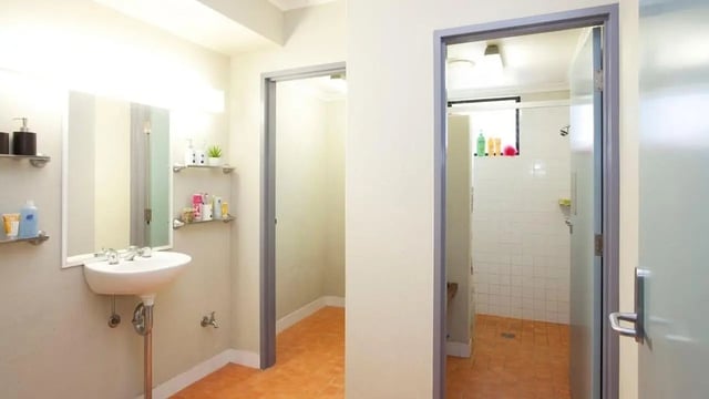 Sink mirror shelves shower stall bathroom at UniLodge SCU Coffs Harbour in Coffs Harbour Student Accommodation