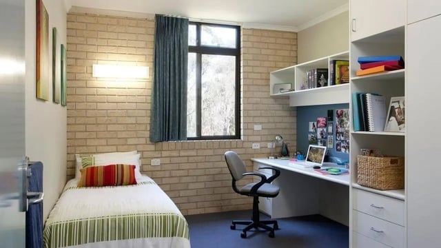 Bed desk chair and shelves bedroom study area at UniLodge SCU Coffs Harbour in Coffs Harbour Student Accommodation