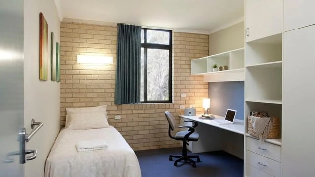 Bed desk chair laptop storage shelves bedroom at UniLodge SCU Coffs Harbour in Coffs Harbour Student Accommodation