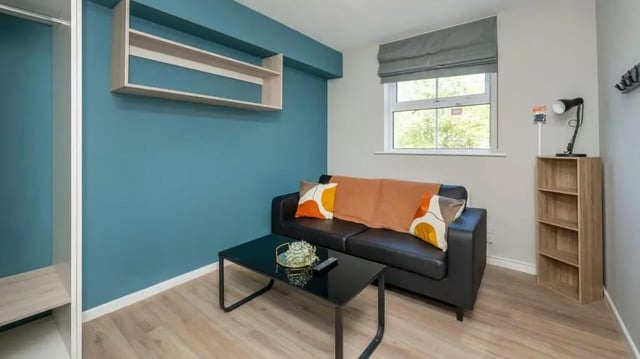 Sofa coffee table bookshelf living room at Emily Davies in Southampton Student Accommodation