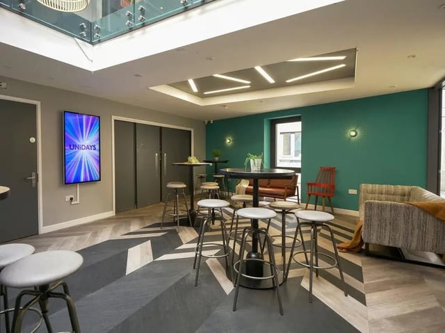 Round tables bar stools couch sofa and TV lounge area at Emily Davies in Southampton Student Accommodation