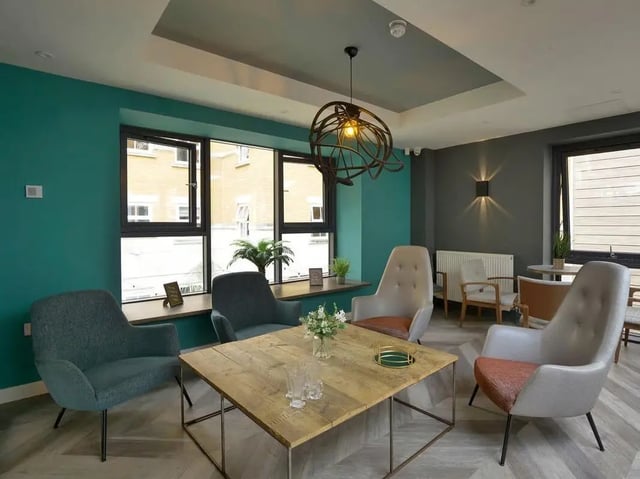 Four armchairs around wooden table living room at Emily Davies in Southampton Student Accommodation