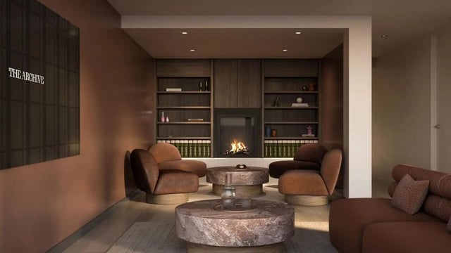 Fireplace bookshelves chairs coffee tables lounge area at The Archive - Residential Living in Melbourne Student Accommodation