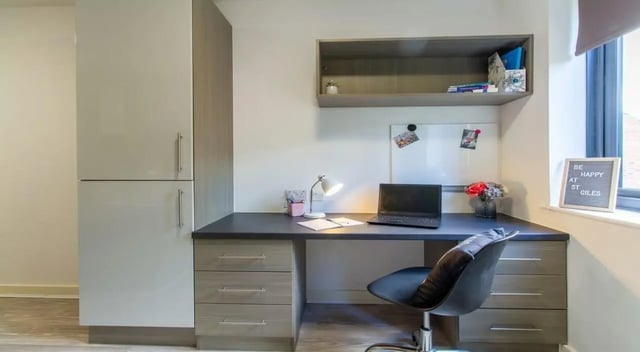 Desk laptop lamp chair and storage study area at St Giles Studios in Durham Student Accommodation