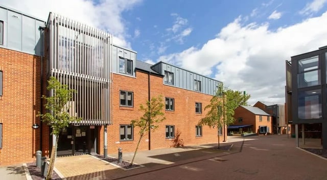 Modern brick building with glass facade exterior at St Giles Studios in Durham Student Accommodation