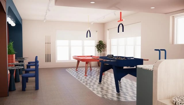 Pool and foosball tables with chairs and plant Recreation room at Selly Oak Court in Birmingham Student Accommodation