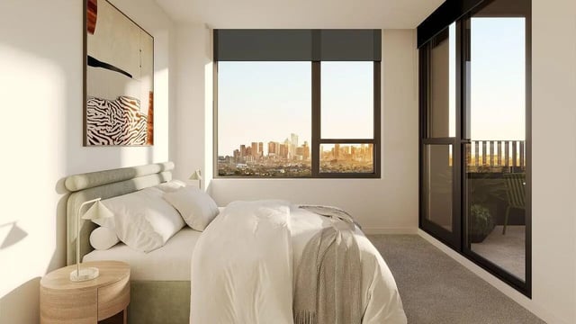 Bed with painting view of cityscape balcony bedroom at WeAreLiving Preston in Melbourne Student Accommodation