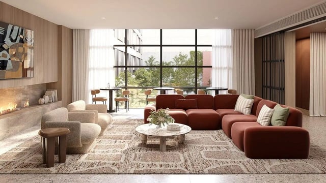Large sectional sofa fireplace and chairs living room at WeAreLiving Preston in Melbourne Student Accommodation