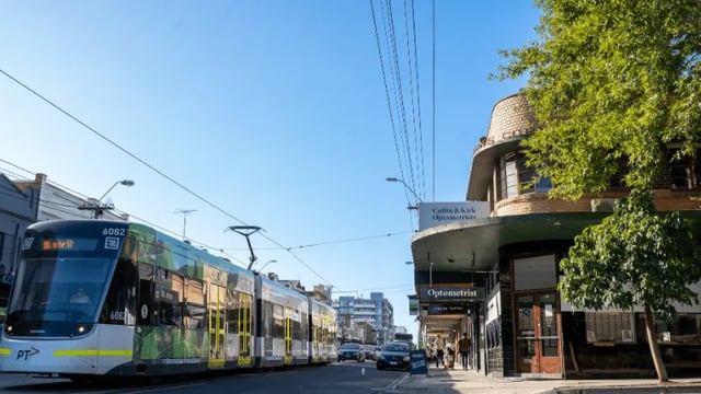 Tram and shops exterior on a street at WeAreLiving Preston in Melbourne Student Accommodation