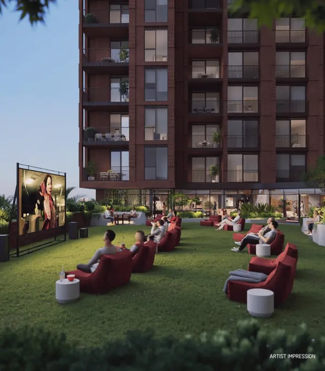 Outdoor cinema with people on beanbags and building exterior living area at Indi Footscray in Melbourne Student Accommodation