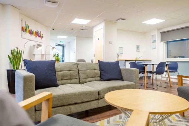 Sofa dining table with chairs kitchen common room at Hollingbury House in Brighton Student Accommodation